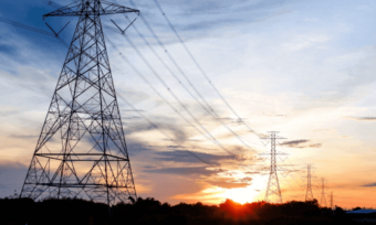 Electricity poles and wires and a sunset