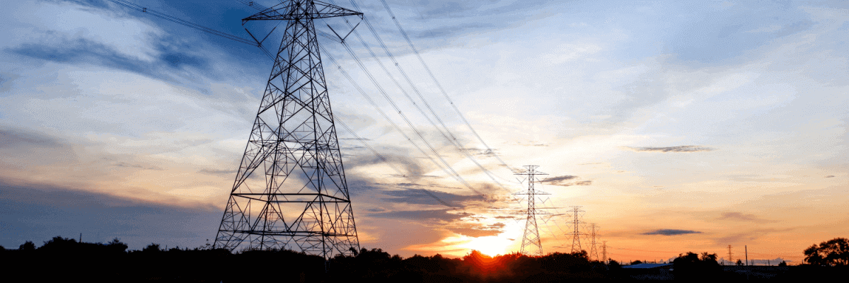 Electricity poles and wires and a sunset