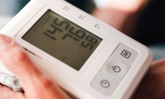 Blood pressure monitor taking someone's blood pressure.