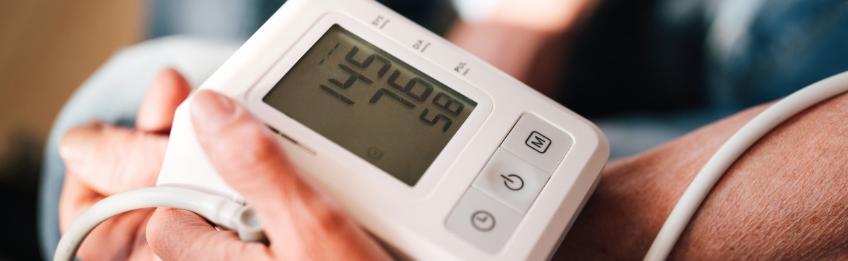 Blood pressure monitor taking someone's blood pressure.