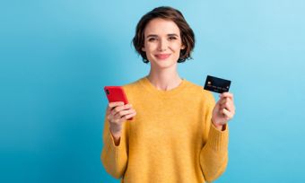 Woman holding phone and credit card