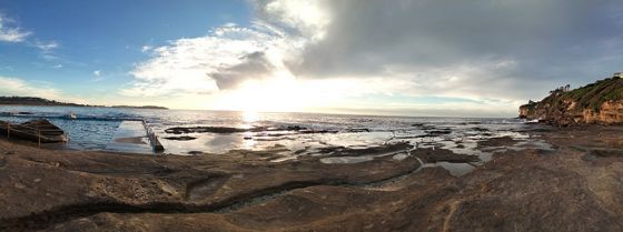 Panorama of ocean and rockpools at sunrise