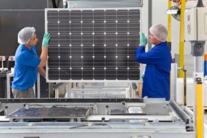 Technicians building a solar panel