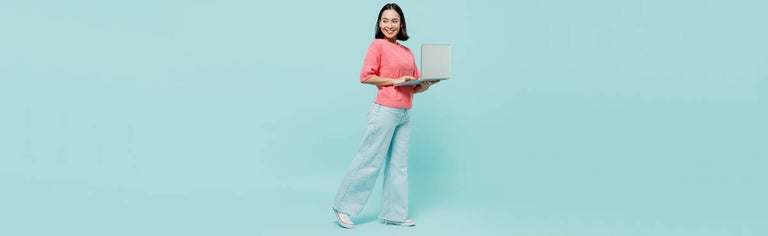 Woman in pink sweater using laptop