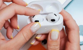 Wireless earbuds in a woman's hands