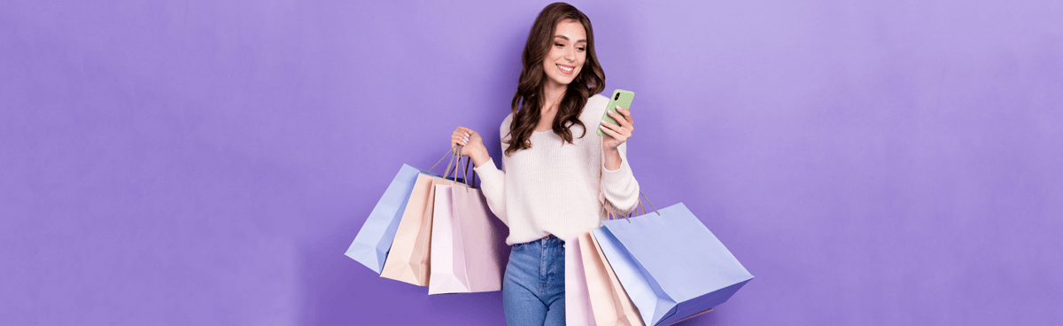 Woman with shopping bags using phone