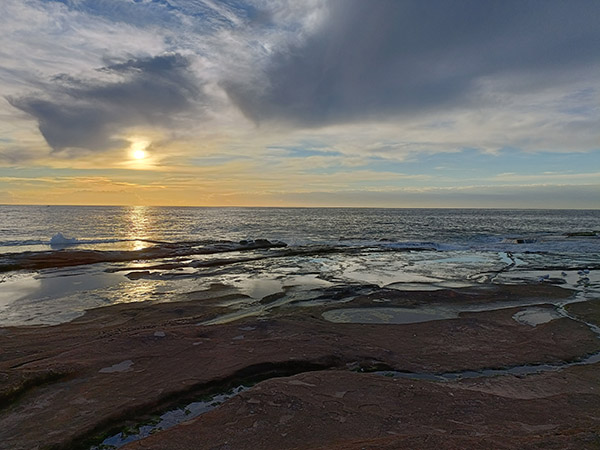 Outdoor photo of rockpool and ocean