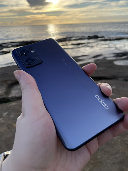 Person holding OPPO Find X5 Lite at beach