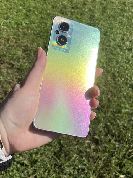 Person holding rainbow OPPO Reno8 Lite 5G phone