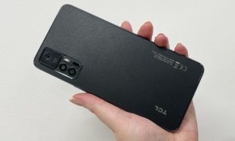 Person holding TCL 30+ phone in black