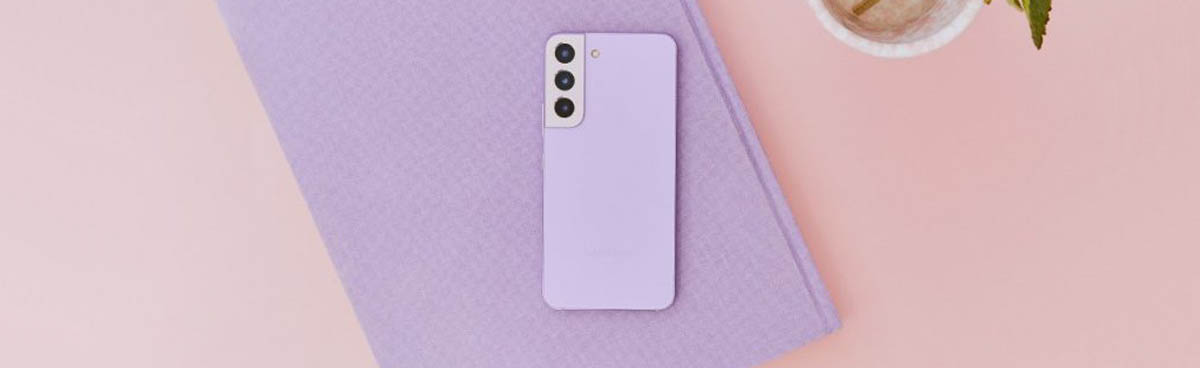 Purple smartphone on a purple notebook