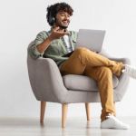 Young man using laptop with headphones