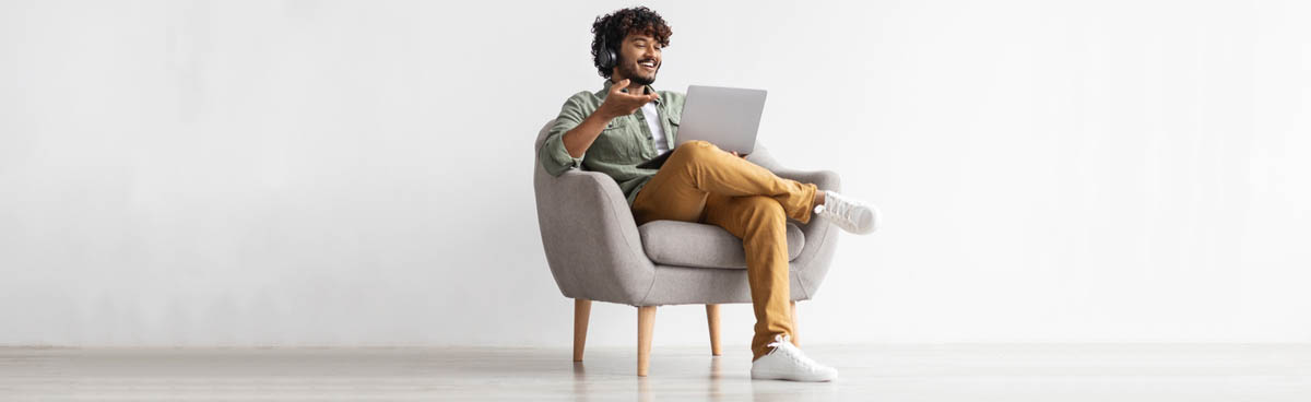 Young man using laptop with headphones