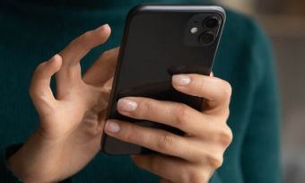 Woman's hands using black iPhone