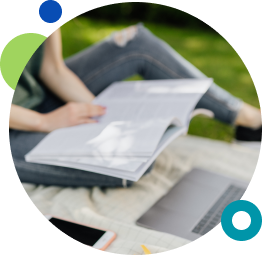 Woman-sitting-on-grass-reading-note-book