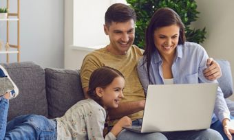 Family looking at laptop in home