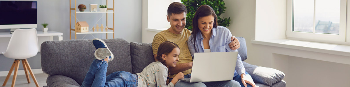 Family looking at laptop in home