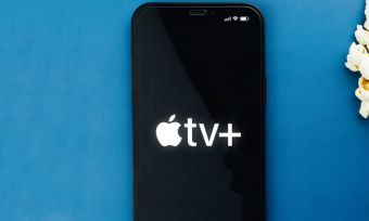 Smartphone showing Apple Tv+ logo next to popcorn