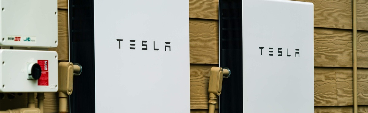Two Tesla Powerwall's on the side of a house.