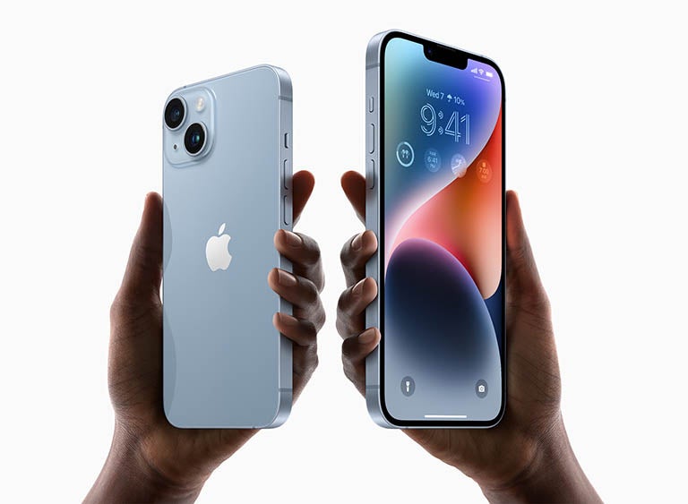 Hands holding iPhone 14 phone in blue 