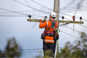 Power company connecting a house to the grid.