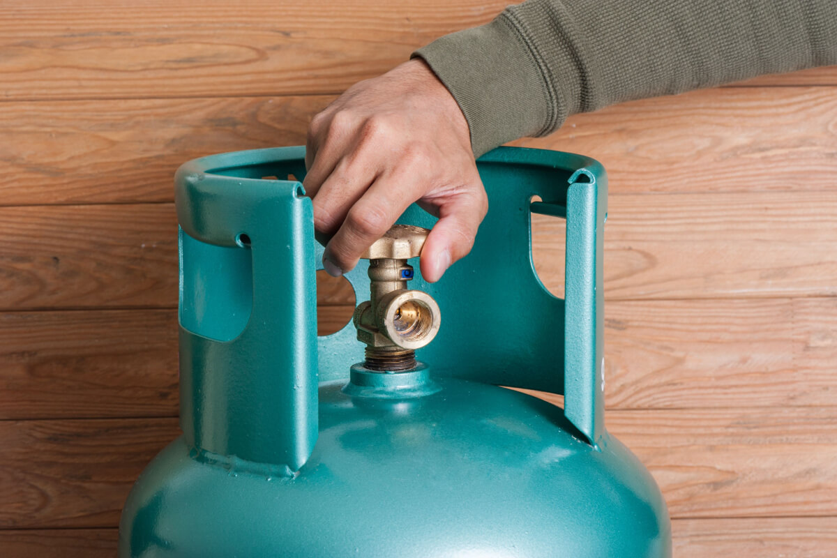 man adjusting LPG bottle