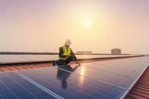 man checking solar panels