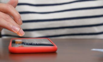 Person on phone, working out savings.