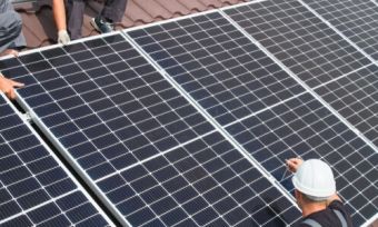 two men on a roof with solar panels