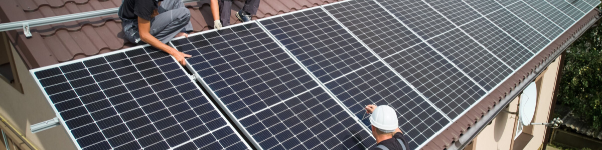 two men on a roof with solar panels