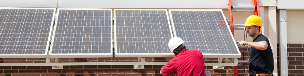 people adjusting solar panels