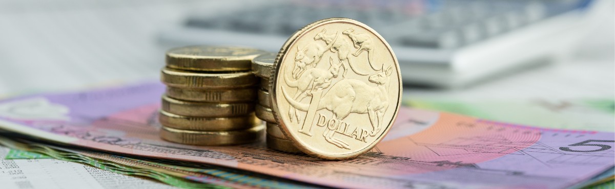 Australian gold coins on top of $5 and $10 notes.