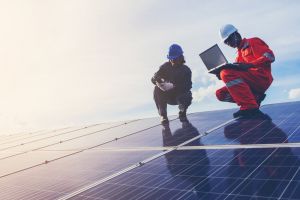 people working on solar panels