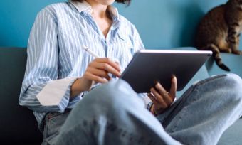 Woman using laptop on sofa