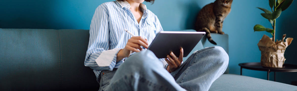 Woman using laptop on sofa