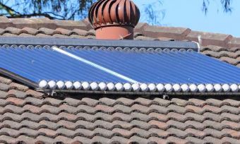 Evacuated solar tubes on rooftop for hot water system.