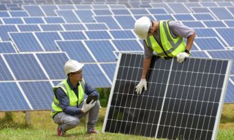 two guys holding a solar panel