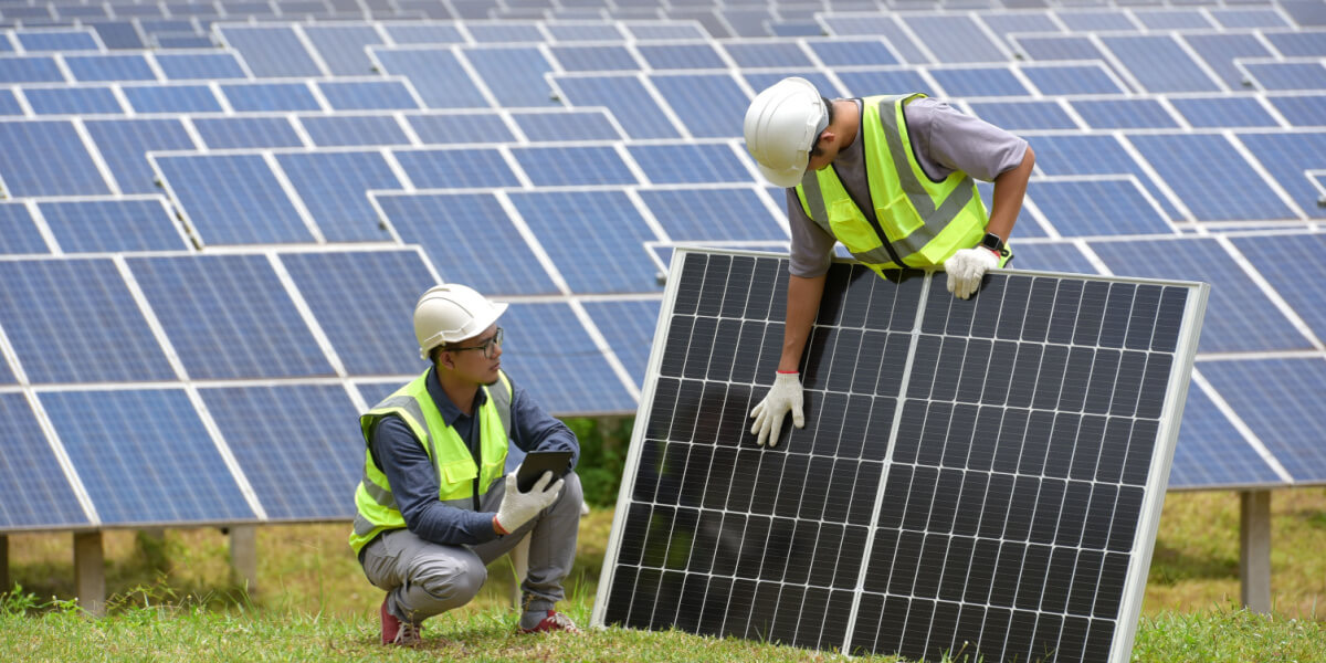 two guys holding a solar panel