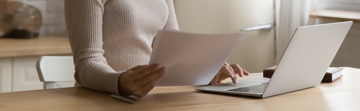 Woman on computer comparing bills.