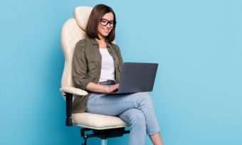 Woman looking at laptop with blue background