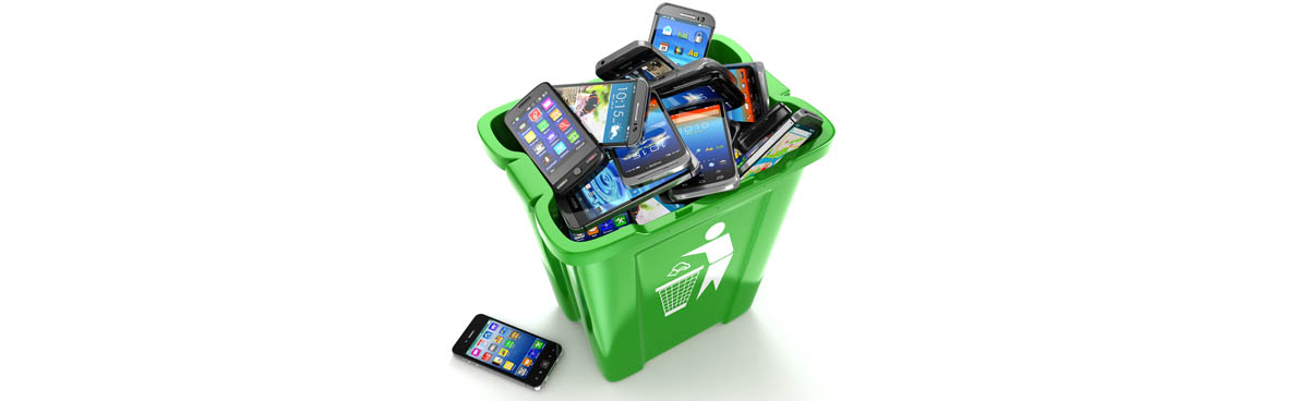 Smartphones piled in a green recycling bin