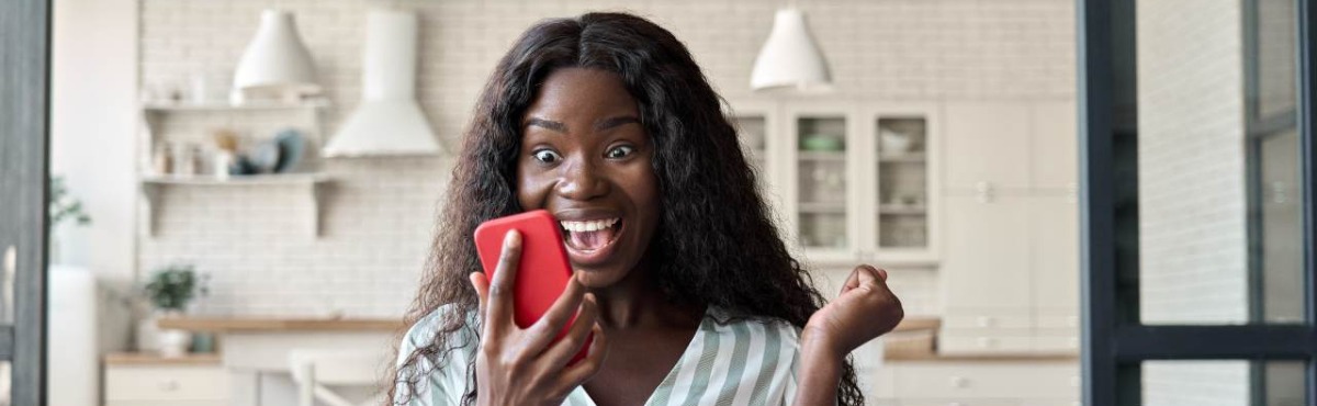 Woman staring at phone, excited.