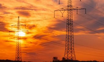 Powerlines with sunset in the background.