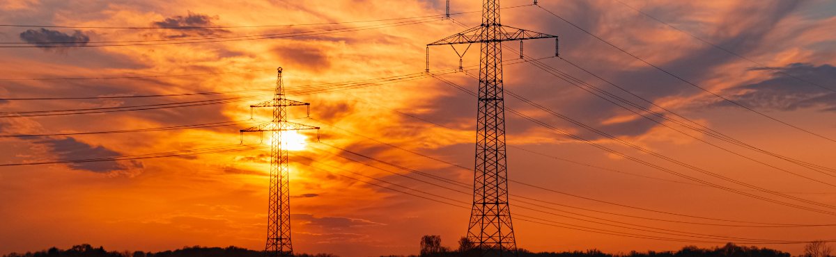 Powerlines with sunset in the background.