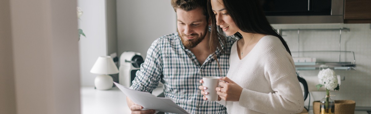 Couple looking happily at their bill.