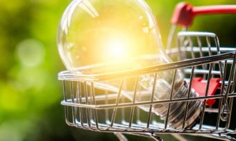 Lightbulb sitting in small shopping trolley outside