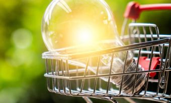 Lightbulb sitting in small shopping trolley outside