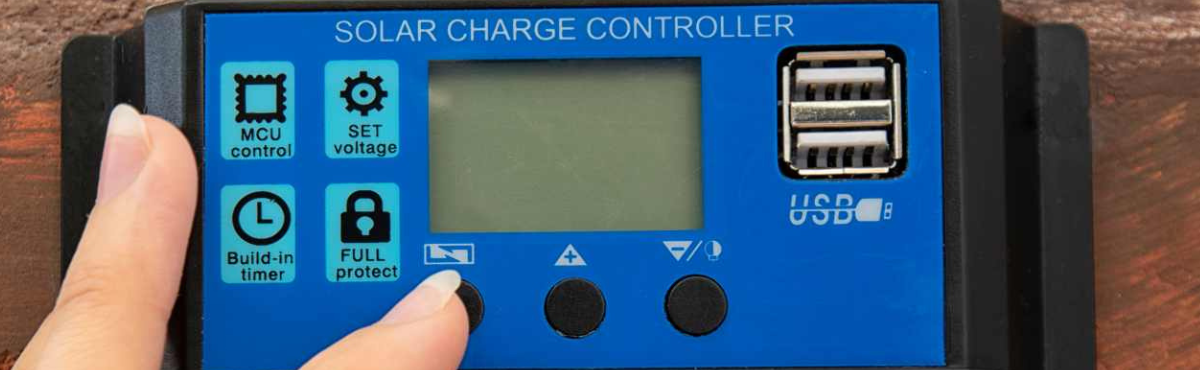 Hands touching button on blue solar charge controller.