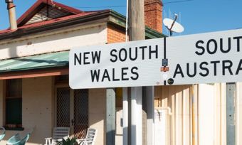 Country Australian town sign with satellite dish in background