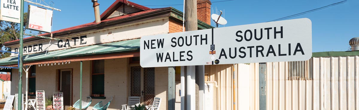 Country Australian town sign with satellite dish in background